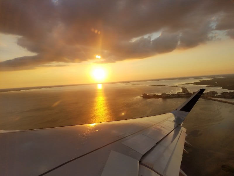 view of a sunset out of the window of a plane